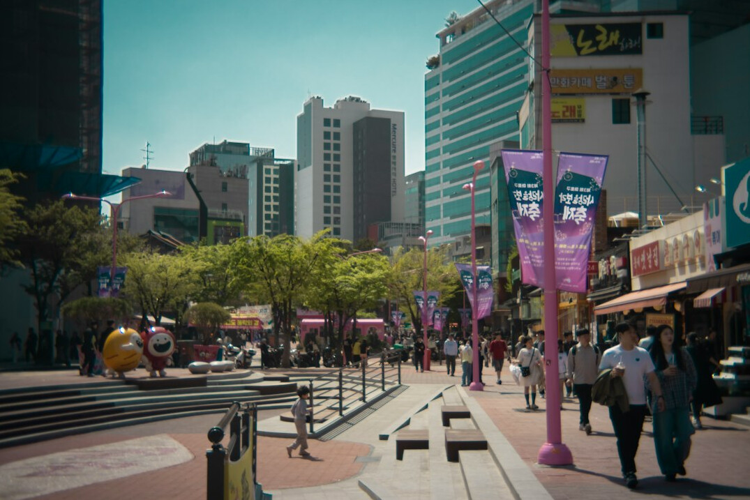 People walking across a city plaza