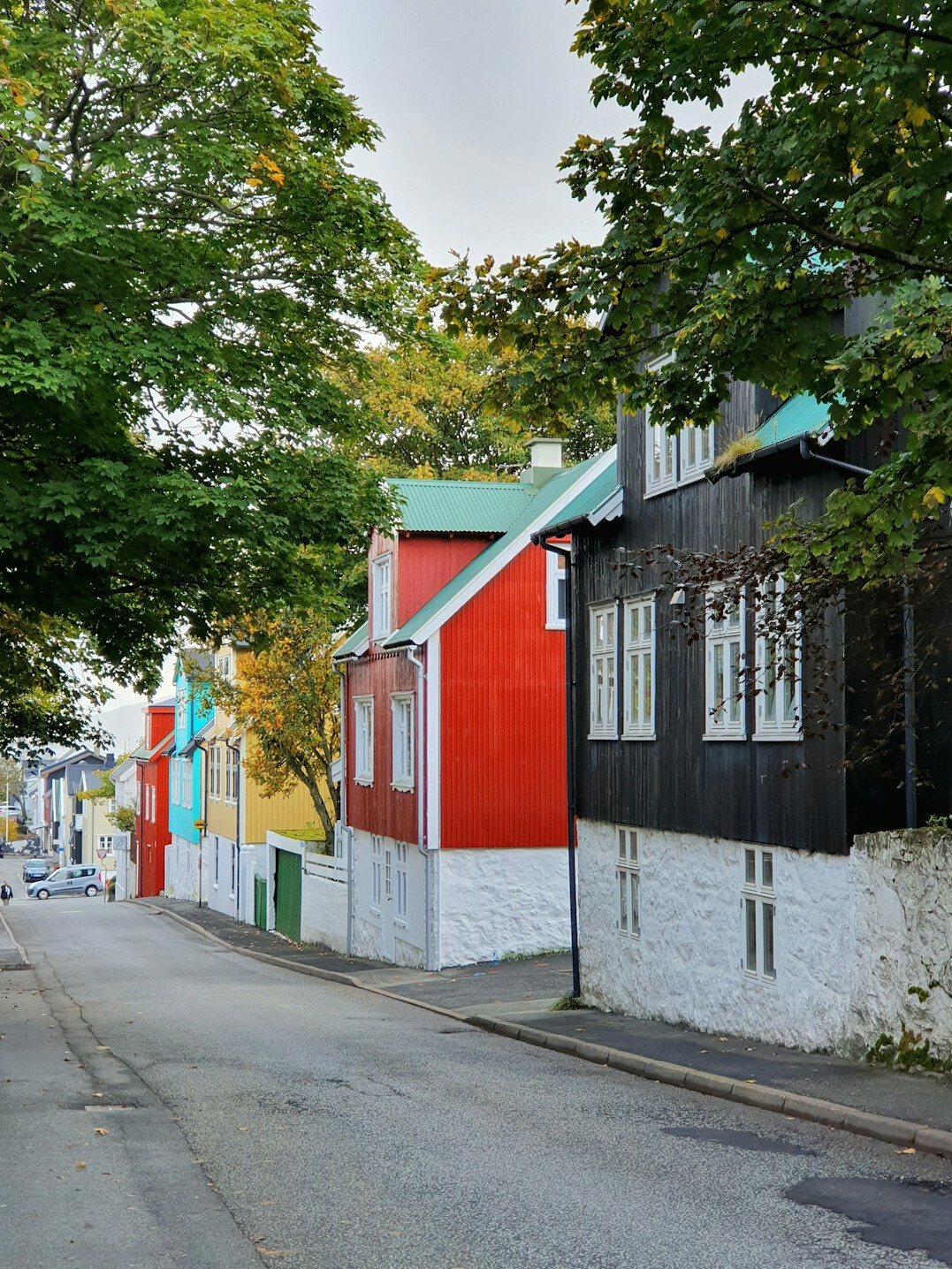 Row of colorful low-rise houses along a quiet street