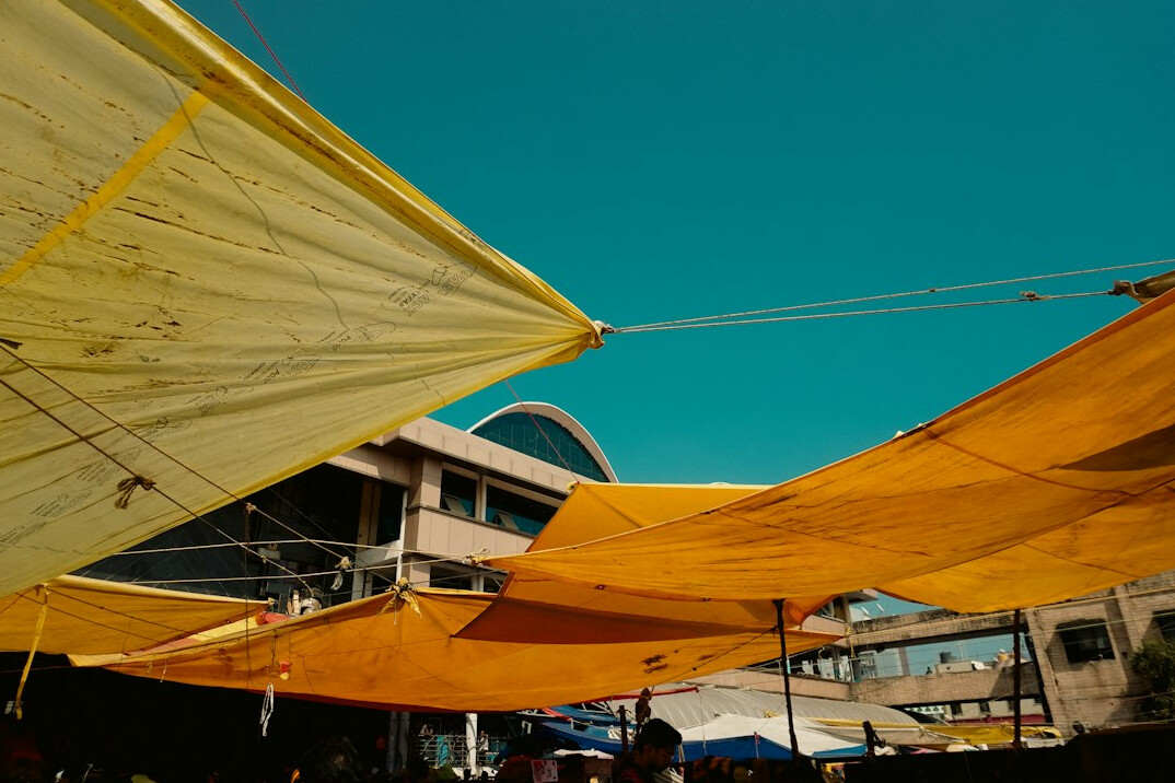 Busy outdoor street market with vendor stalls